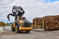 Grapple loader in the lumber yard of a woodworking plant