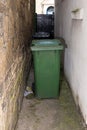 Wheelie bins in a dingy British alley way