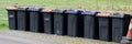Wheelie bins in row for refuge collection outdoors Royalty Free Stock Photo