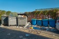 Wheelie bins and rubbish aligned in Margate street under blue sky