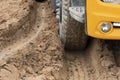 Wheels of a large truck run on a muddy road. Royalty Free Stock Photo