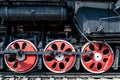 Wheels of the old locomotive of red color and the elements of the drive Royalty Free Stock Photo