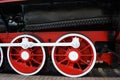 Wheels of an old steam locomotive close-up, wheels of a steam locomotive in red. Royalty Free Stock Photo