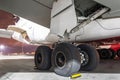 Wheels rubber tire rear landing gear racks airplane aircraft, under wing view night. Royalty Free Stock Photo