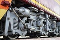 Wheels of a Russian modern locomotive, view from side. Transportation industry concept. Heavy wheels and mechanism under the elec