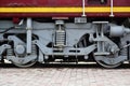 Wheels of a Russian modern locomotive, view from side. Transportation industry concept. Heavy wheels and mechanism under the elec