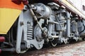 Wheels of a Russian modern locomotive, view from side. Transportation industry concept. Heavy wheels and mechanism under the elec