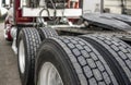 Wheels with tires on axels of big rig semi truck standing on parking lot Royalty Free Stock Photo