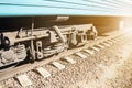 wheelset under the car on the electric train close-up at sunset Royalty Free Stock Photo