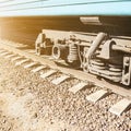 wheelset under the car on the electric train close-up at sunset Royalty Free Stock Photo