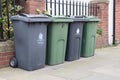 Wheely bins on pavement awaiting collection with North Tyneside Council crest and signage