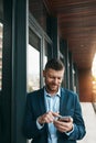 Whenever he steps out, his connections follow. a mature businessman using his cellphone on the office balcony. Royalty Free Stock Photo