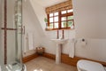 Bathroom with corner shower, sink and toilet