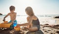 Where the best childhood memories are made. an adorable little boy and girl playing with toys in the sand at the beach. Royalty Free Stock Photo