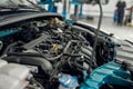 Close up of a car with open hood under under maintenance in auto repair shop Royalty Free Stock Photo