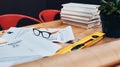 Where great designs are made. Still life shot of a pair of spectacles placed on top an architects blueprints in a modern