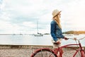 Where am I going to drive to today. a calm young woman wearing a hat and getting ready to ride her bicycle while looking