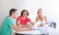 This is where ideas are born. three businesspeople gathered around a table in the office.