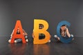 Where literacy starts. Studio portrait of a diverse group of kids holding up letters of the alphabet against a gray Royalty Free Stock Photo