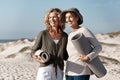 Where should we set up. two attractive mature woman standing with their on the beach. Royalty Free Stock Photo