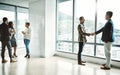 Where successes are made. group of businesspeople walking around and having casual chats with each other in the office.