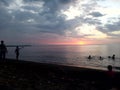 where sunset takes a peek behind the clouds Sedayu lombok beach Royalty Free Stock Photo
