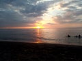 where sunset takes a peek behind the clouds Sedayu lombok beach Royalty Free Stock Photo