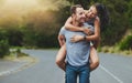 Where theres love, youll never walk alone. a happy young couple enjoying a piggyback ride outdoors.