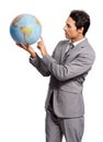 Where to next. A young executive pointing out something on a world globe - isolated. Royalty Free Stock Photo