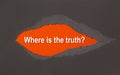 Where is the truth - appearing behind torn brown paper
