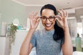 Where vision meets fashion. Shot of a young woman buying a new pair of glasses at an optometrist store. Royalty Free Stock Photo