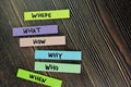 Where, What, How, Why, Who, When write on sticky note and isolated on Wooden Table