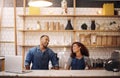 Where would we be without each other. two young business owners standing in their cafe and looking at each other.