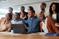 Where would we be without our work family. a group of young businesspeople using a laptop at a conference in a modern Royalty Free Stock Photo