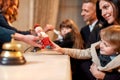 Where you always feel at home. Happy family checking in hotel at reception desk. Hotel worker is giving a toy for a boy Royalty Free Stock Photo