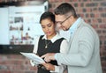 Wheres the addendum for this line. two businesspeople looking over some paperwork in the office.