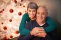 Wheres that mistletoe. Cropped portrait of a happy mature couple sitting in their home at Christmastime.