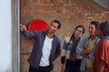 Wheres my name on the results list...a group of university students looking at a notice on a wall.