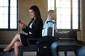 Wherever you go, stay connected. a confident businesswoman using her smartphone while waiting in an airport terminal. Royalty Free Stock Photo