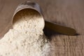 Whey Protein. Dropped scoop with vanilla powder flavour. Wooden Royalty Free Stock Photo