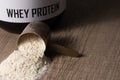 Whey Protein. Dropped scoop with vanilla powder flavour. Wooden Royalty Free Stock Photo