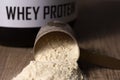 Whey Protein. Dropped scoop with vanilla powder flavour. Wooden Royalty Free Stock Photo