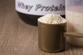 Whey Protein. Golden scoop with vanilla flavour powder, shaker a Royalty Free Stock Photo