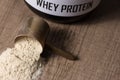 Whey Protein. Golden scoop on wooden background with vanilla pow Royalty Free Stock Photo