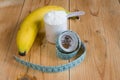 Whey protein with measuring tape and banana Royalty Free Stock Photo