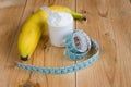 Whey protein with measuring tape and banana Royalty Free Stock Photo