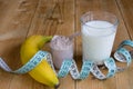 Whey protein with measuring tape, milk and banana Royalty Free Stock Photo