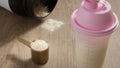 Whey Protein. Dropped black jar and spilled powder. Yellow measuring scoop. Selective focus and wooden table. Royalty Free Stock Photo