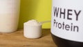 Whey Protein. Front view of scoop with vanilla powder, jar and s Royalty Free Stock Photo