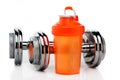 Whey protein shaker and dumbbells.